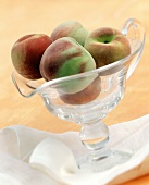 Peaches in glass bowl