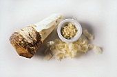 Half peeled horseradish root and grated horseradish