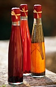 Three vinegar bottles with various types of vinegar