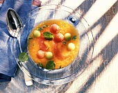 Cold melon soup on glass plate