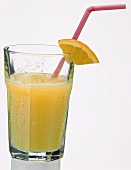 A glass of orange juice with straw