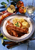 Sausage wrapped in bacon with apple slice & mashed potato
