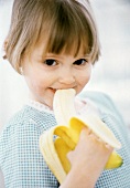Little Girl Eating a Banana