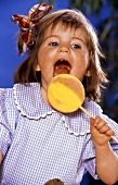 Young Child Licking a Lollipop