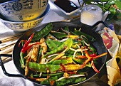Mangetouts with sweetcorn and beansprouts in a wok