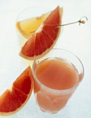 Red Grapefruit Juice in a Glass with Grapefruit Wedges