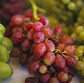 Red grapes among green grapes
