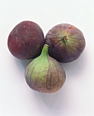 Three fresh figs on white background