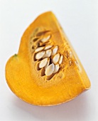 Segment of orange pumpkin with seeds
