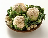 Cauliflower in a brown bowl on white background