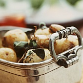 Baked sage potatoes in a roasting dish