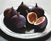 Fresh figs on a plate, one halved