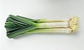 Three leeks, lying on top of each other