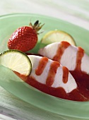 Yoghurt and lime mousse with strawberry sauce