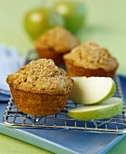 Apple muffins on a cake rake with apple wedges