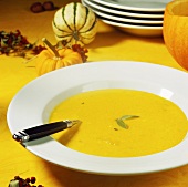 Pumpkin soup with sage on plate