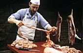 Butchering a pig: separating the small intestine 