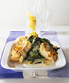 Fried red perch fillet with spinach and flaked almonds