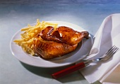 Fried chicken & chips on plate,  cutlery & napkin beside it