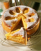 Pear and almond cake with icing sugar, a piece cut