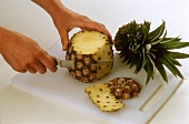 Removing the skin from pineapple