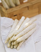 Bundle of white asparagus, & in crate behind
