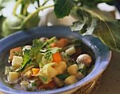 Kohlrabi stew with sausage dumplings on blue plate