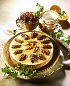 Carrot & date cake on cake plate garnished with dates