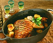 Roast suckling pig with potatoes and garlic