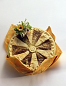 Cheese pie with herbs against white background