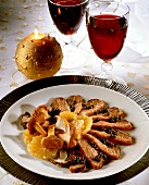 Duck breast with orange slices, green peppers and mushrooms