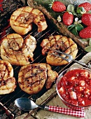 Grilled belly pork on grill rack, strawberry sauce beside it
