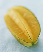 A carambola on pale blue background