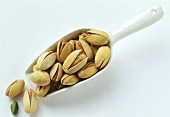 Pistachios on and beside a scoop