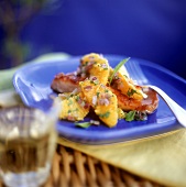 Fried fish fillet with oranges and edible flowers