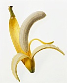 Peeled banana and banana skin