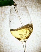 Pouring white wine into a glass