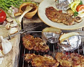 Pork neck with baked potatoes on the barbecue