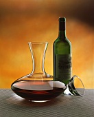 Decanting: filled carafe, empty red wine bottle