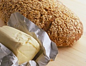 Mixed-grain bread with sesame and pat of butter