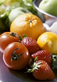 Still life with tomatoes, strawberries, orange, lemon etc