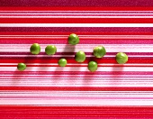 Shelled peas on striped background