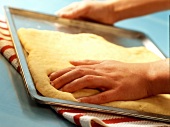 Putting yeast dough on a baking tray