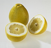 Whole and halved pomelo