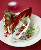 Salad leaves with pomegranate seeds on plate