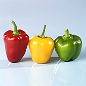 Red, yellow and green peppers, side by side