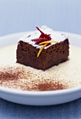 A piece of beetroot chocolate cake on ginger sabayon