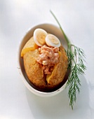Baked potato with shrimp cocktail, quail's egg and dill