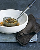 Mushroom soup with barley on ladle