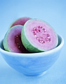 Halved guavas in bowl